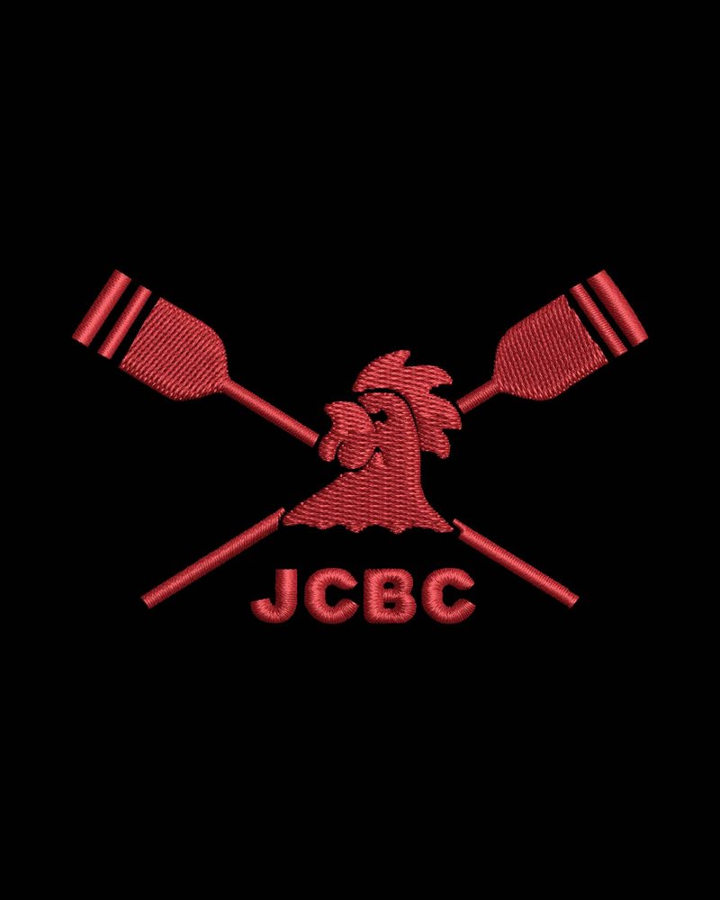 Close-up of the red JCBC embroidery: crossed oars, cockerel and JCBC